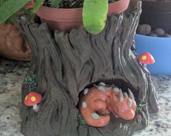 Hand painted sleeping dragon tree stump planter.