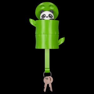 May include: A green plastic key holder shaped like a bamboo stalk with a small panda figure emerging from the top. The cylindrical bamboo container features two small leaves on the sides and a vertical strap extending downward to a metal ring holding two keys.