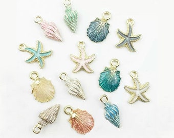 May include: Assortment of gold-tone metal charms featuring seashells and starfish in various colors, including pink, blue, green, and white.