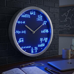 May include: A round wall clock with a silver frame and a dark blue face illuminated by a blue light. Instead of numbers, the face features various mathematical equations including 6x2, 124-123, square root of 4, 66/198, 50/2=100/x, 126/630, 1/8*96/2, 52-x+x=10, square root of 64, 3(pi-.14), -8=2-x, and 111/1221. The clock has two simple silver hands.