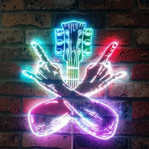 May include: Neon sign featuring a guitar and crossed hands making the rock and roll hand gesture. The sign has a brick background and is illuminated with blue, green, red, and purple neon lights.