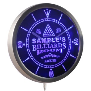 May include: A blue LED clock with a silver frame. The clock face features a billiard ball rack, the text "SAMPLE'S BILLIARDS ROOM", and the words "COLD BEER", "GOOD TIMES", and "RACK 'EM".