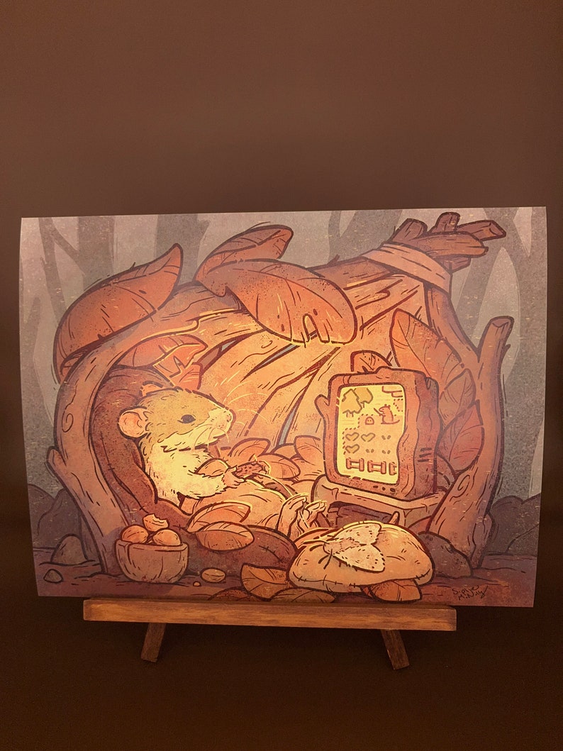 May include: A cartoon illustration of a small, brown mouse sitting in a cozy, leafy nest and watching a television screen with a video game on it. The mouse is holding a controller and has a relaxed expression. The nest is made of leaves and branches, and there are nuts and other forest elements scattered around.