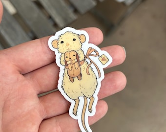May include: A sticker of a white mouse holding a small stuffed animal with a heart-shaped tag that says "love".
