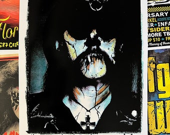 May include: A black and white illustration of a person with a skull face wearing a black hat with a skull and crossbones design. The person is wearing a black leather jacket and a silver necklace with a cross pendant. The text "... Killed by Death" is written below the image.