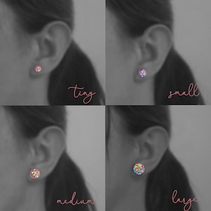 May include: Four images showing different sizes of rainbow glitter stud earrings. The earrings are shown on a model's ear. The sizes are labeled "tiny", "small", "medium", and "large".