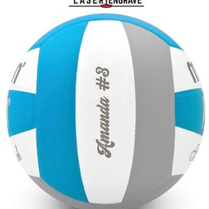 May include: A personalized volleyball with blue, white, and gray panels. The text "Amanda #3" is displayed on the ball. The words "LASER ENGRAVE" are above the ball.