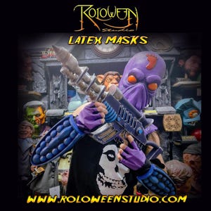 May include: A purple latex mask with orange eyes and a red footprint design, holding a futuristic weapon. The mask is part of a Halloween costume. The image also displays the text "LATEX MASKS" and "WWW.ROLOWEENSTUDIO.COM".