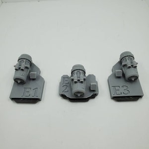 May include: Three gray 3D printed engine models with labels E1, E2, and E3.