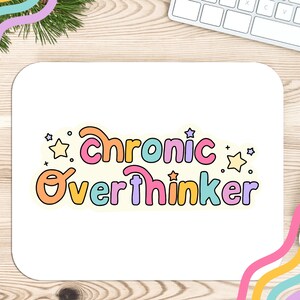May include: White mouse pad with the text "chronic overthinker" in colorful, outlined letters. The text is surrounded by small yellow stars.