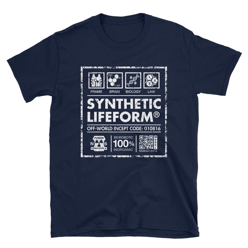 May include: A navy blue t-shirt featuring a white graphic of a label that reads "SYNTHETIC LIFEFORM&reg;" with the text "OFF-WORLD INCEPT CODE: 010816" and a QR code. The label also includes the text "FRAME, BRAIN, BIOLOGY, LAW" and "BIOROBOTIC 100% INORGANIC".