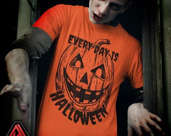 May include: An orange t-shirt featuring a black jack-o'-lantern design and the words "EVERY DAY IS HALLOWEEN." This item is part of a Halloween-themed collection.