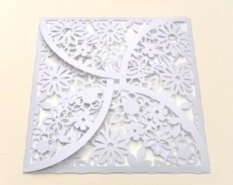 May include: White square envelope with a delicate floral pattern cut out. The pattern is intricate and features small flowers and leaves.