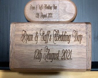 May include: A wooden box with a lid engraved with the text "Ryan & Saff's Wedding Day 12th August 2021."