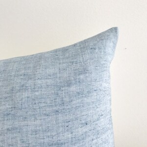 May include: A light blue linen pillow cover with a subtle textured pattern.
