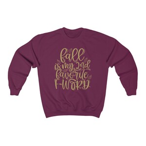May include: Burgundy sweatshirt with the text "fall is my 2nd favorite f-word" in gold lettering.