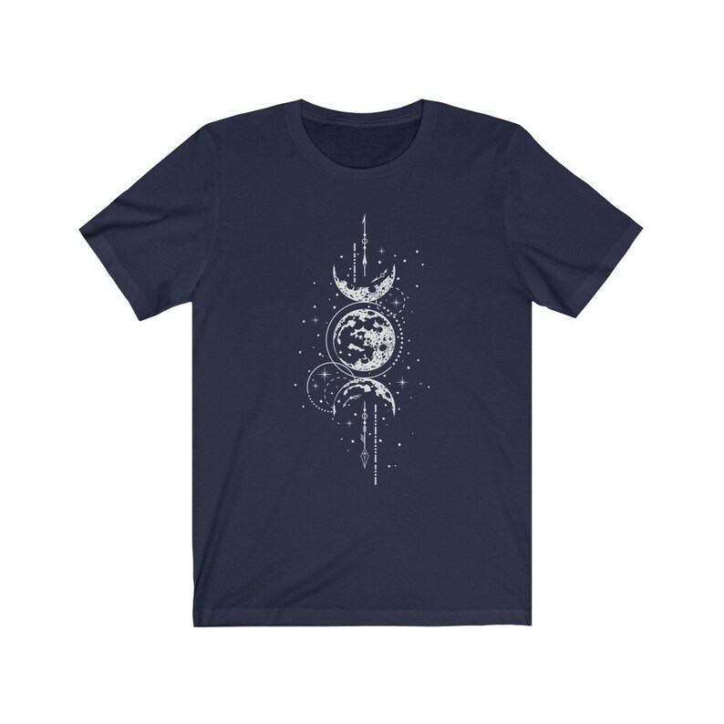 May include: A navy blue t-shirt with a white graphic of three moons in different phases, surrounded by stars and a geometric design.