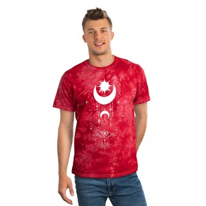 May include: A red tie-dye t-shirt with a white sun, moon, and eye design. The design features a crescent moon with a sun inside, two smaller moons, and an eye with a triangle above it.