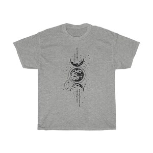 May include: A heather gray t-shirt featuring a black graphic of the phases of the moon. The design includes crescent moons, a full moon, stars, and lines. The shirt is a casual, unisex style.