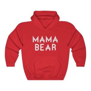 May include: Red hooded sweatshirt with the text "MAMA BEAR" in white outlined letters.