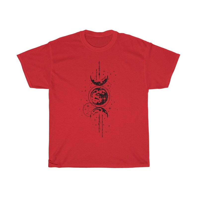 May include: A red t-shirt featuring a black graphic of the phases of the moon. The design includes crescent moons, a full moon, and dotted lines, creating a celestial theme. The shirt is made of a soft material.