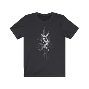 May include: A black t-shirt with a white graphic design of three moons in different phases, surrounded by stars and geometric shapes.