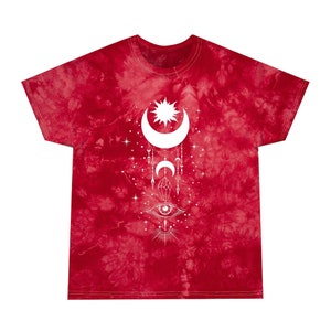 May include: Red tie-dye t-shirt with a white graphic of a crescent moon, sun, eye, and other celestial symbols.