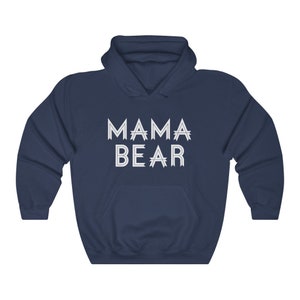 May include: A navy blue hooded sweatshirt with the text "MAMA BEAR" printed in white on the front.