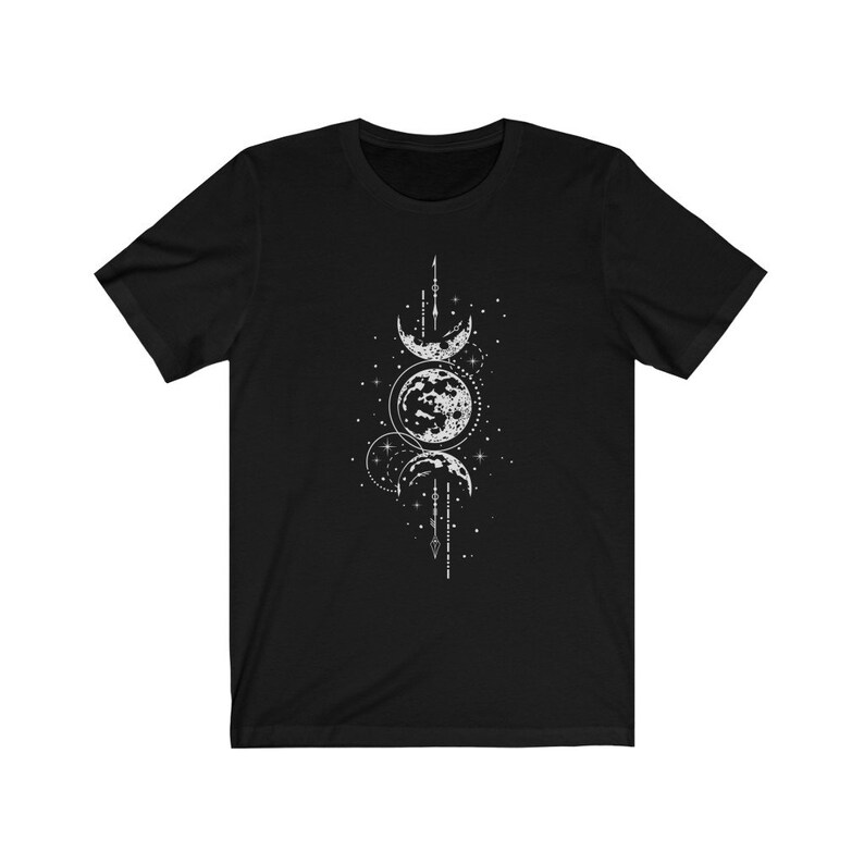 May include: Black t-shirt with a white graphic of three moons in different phases, surrounded by stars and a geometric design.
