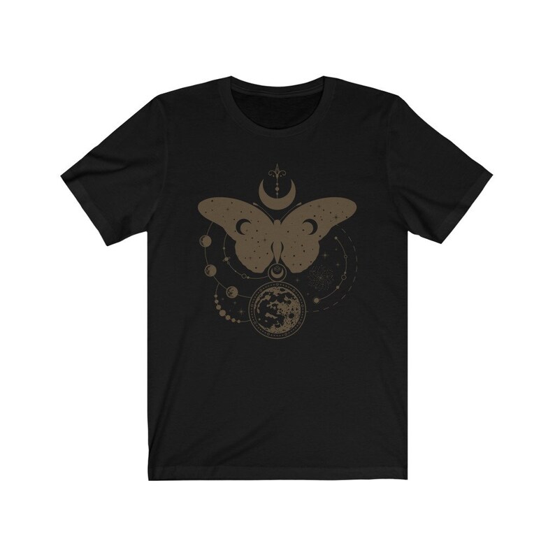 May include: Black t-shirt with a brown graphic of a butterfly with a moon and stars around it.