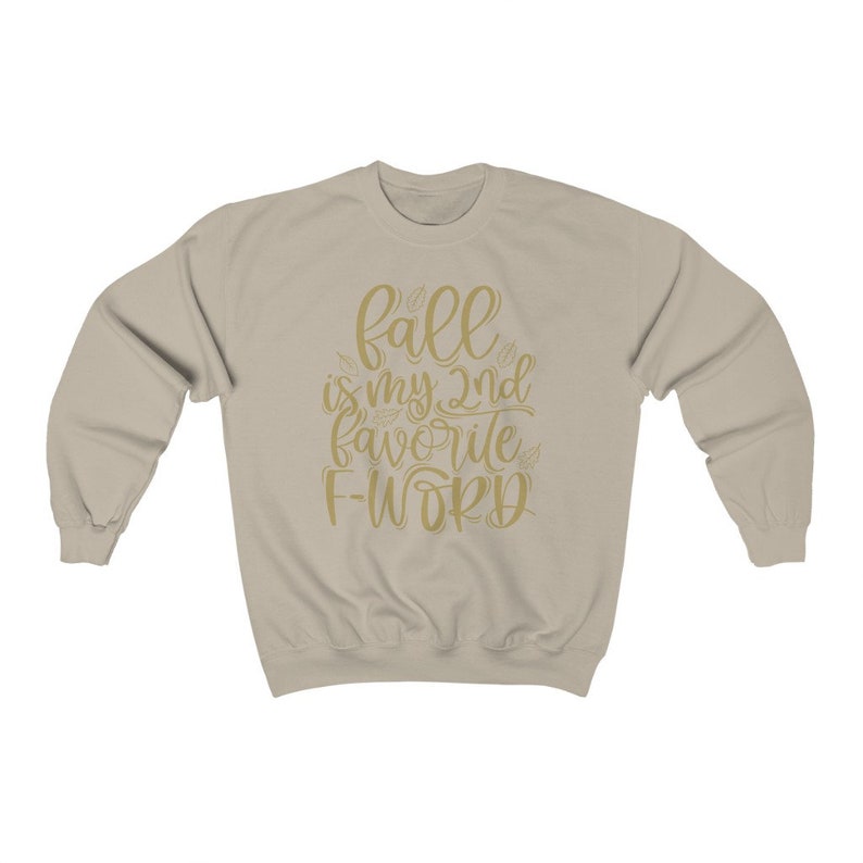 May include: A beige sweatshirt with the text "fall is my 2nd favorite f-word" in gold lettering.