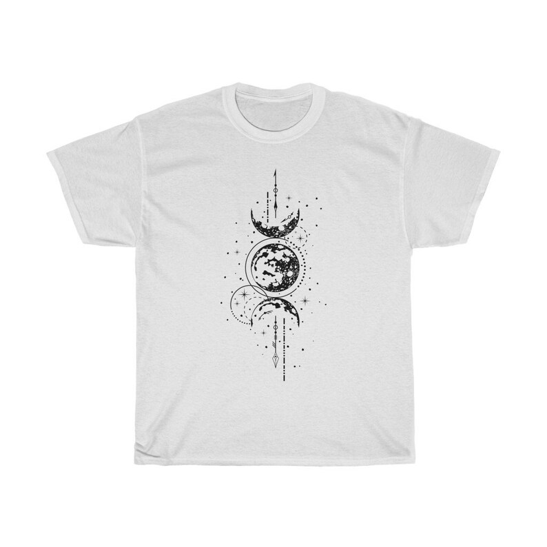 May include: White t-shirt featuring a black graphic of the phases of the moon, stars, and celestial lines. The design is centered on the front of the shirt. The shirt is made of a soft, comfortable material.