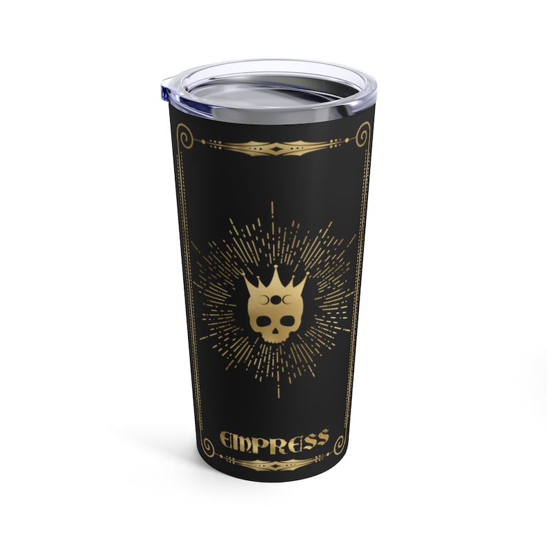 May include: A black stainless steel tumbler with a gold design. The design features a skull with a crown and the word "Empress" below it.