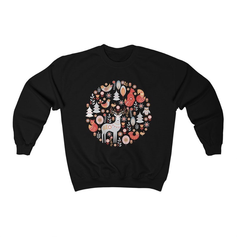 May include: Black sweatshirt with a circular design featuring a deer, birds, trees, and flowers in shades of red, pink, and white.