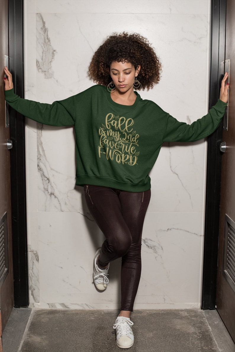 May include: A green sweatshirt with the text "Fall is my 2nd favorite F-word" in gold lettering.