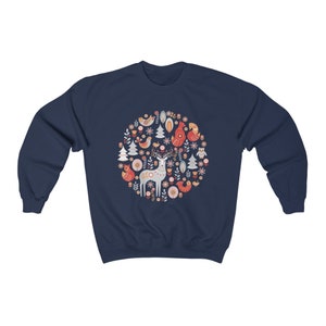May include: Navy blue sweatshirt with a circular design featuring a deer, birds, and flowers in red, white, and blue.