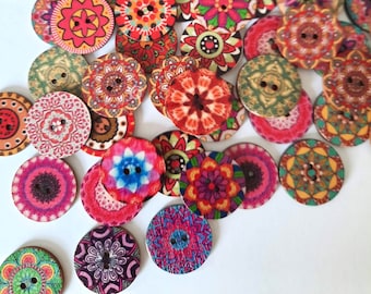 May include: Assortment of colorful wooden buttons with intricate mandala designs. The buttons are round and feature various shades of red, blue, green, and pink.