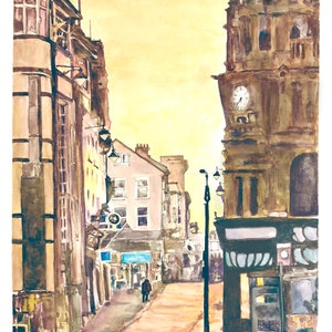 May include: A watercolor painting of a street scene in a city. The buildings are old and have a lot of character. The street is empty except for one person walking down the middle. The sky is a light yellow color.