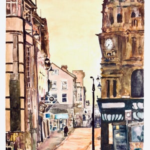 May include: A watercolor painting of a street scene in a city. The buildings are painted in shades of brown and gray, and the street is paved with cobblestones. There is a clock tower on the right side of the image, and a single person walking down the street.
