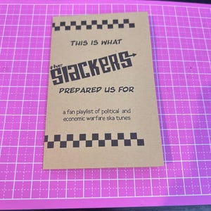 May include: A brown card with black and white checkered borders and text. The text reads "THIS IS WHAT the Slackers PREPARED US FOR" and "a fan playlist of political and economic warfare ska tunes."