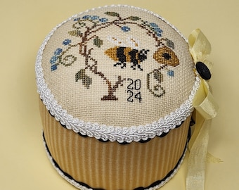 Jeanette Douglas cross-stitched CHUBBY BEE PINDRUM on 32 count Beige Linen Aida with Gimp, Rickrack & Ribbon Trims, Buttons, Charm 5 x 4 in