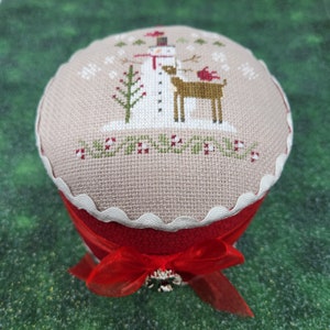 Brenda Gervais cross-stitched RUDOLF & FRIENDS DRUM on 32 count Mocha Linen Aida with Pearls, Buttons, Rickrack, Wreath Charm, Ribbon