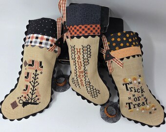 Blackbird Designs cross-stitched HALLOWEEN STOCKINGS on 32 count Mocha Linen Aida with Rickrack, Bias, Ribbon, Button 9 x 5 inches