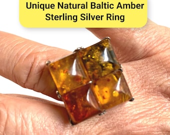 Puede incluir: Anillo de plata de ley con cuatro piedras cuadradas de ámbar báltico natural. Las piedras de ámbar presentan tonos dorados y rojizos. El texto "Unique Natural Baltic Amber Sterling Silver Ring" es visible.