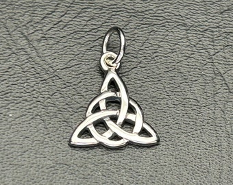 May include: A silver Celtic knot pendant charm with a triangular shape and intricate knotwork design. The pendant has a loop at the top for attaching to a chain or necklace.