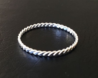 May include: A silver twisted band ring.