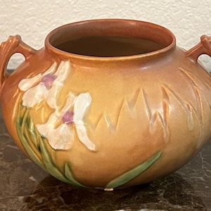 May include: A handmade wooden sign with the text "Welcome to our home" in a handwritten style. The sign is painted white with a dark stained frame. The sign is 12 inches wide and 8 inches tall.