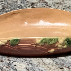 May include: A set of three ceramic mugs with a speckled, matte finish. The mugs are in shades of cream, light gray, and dark gray. Each mug has a simple, minimalist design, perfect for coffee or tea.