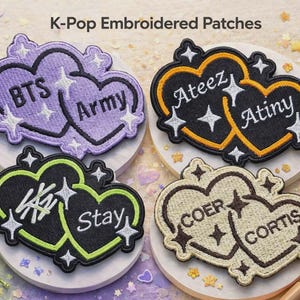 May include: K-Pop embroidered patches in heart shapes. The patches feature the text "BTS Army", "Ateez Atiny", "Stay", and "Coer Cortis". Each patch has a different color scheme, including purple, black, and green.