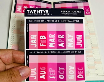May include: Pink and white monthly calendar stickers with the months of the year printed in black. The stickers are labeled "Cycle Tracker, Period Log, Menstrual Cycle" and "Cycle Tracking, Period Log, Menstrual Cycle".